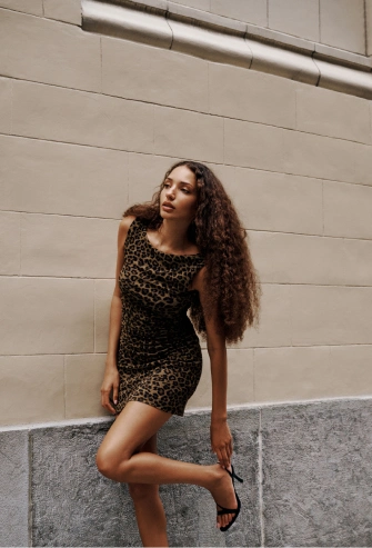 Model is wearing a leopard print mini dress.